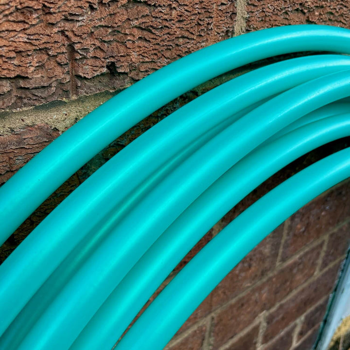 Caribbean Breeze Hula hoops resting against a brick wall