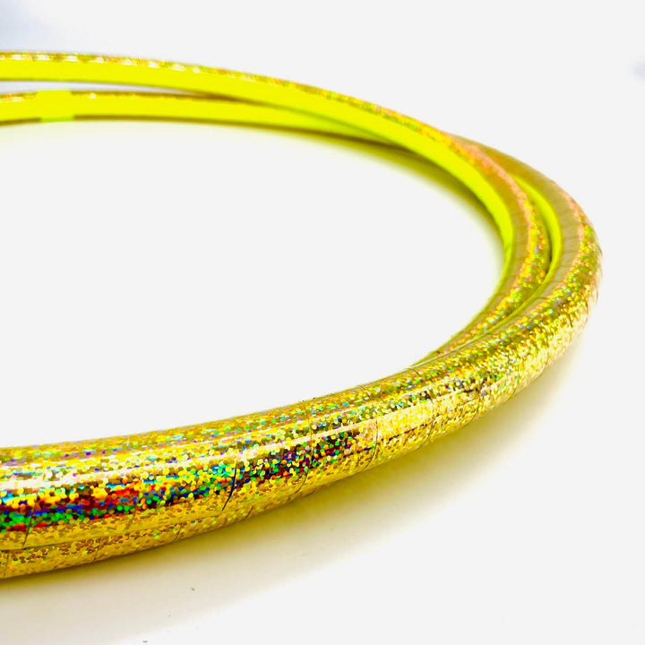 Gold holographic all shiny travel hula hoop against a white background