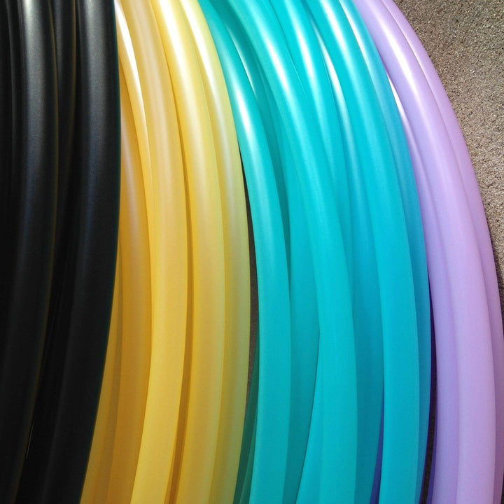 Hoop stack, Aqua tubing paired with uv orange hoops and purple hoop tubing. Pastel hula hoops
