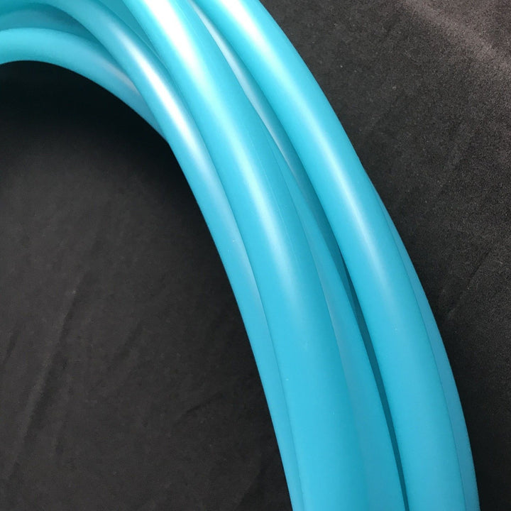 Aqua Seaglass polypro hoop. Beautiful hula hoop in sea coloured tubing. This hoop is blue transparent tubing that allows the light through making is vibrant in the sunshine.